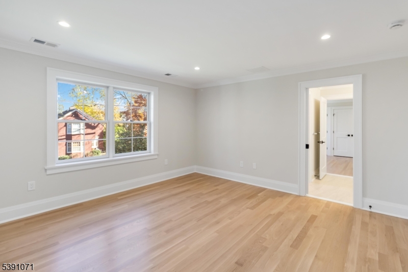 2 Whitman Drive Chatham, NJ 07928 - Photo 31 of 50 an empty room with wooden floor and windows