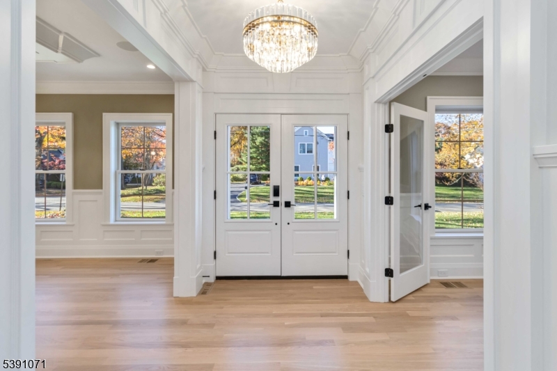 2 Whitman Drive Chatham, NJ 07928 - Photo 4 of 50 an empty room with wooden floor fan and windows