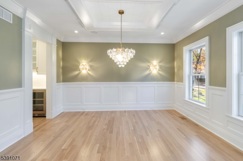2 Whitman Drive Chatham, NJ 07928 - Photo 9 of 50 a view of a room with wooden floor chandelier and windows