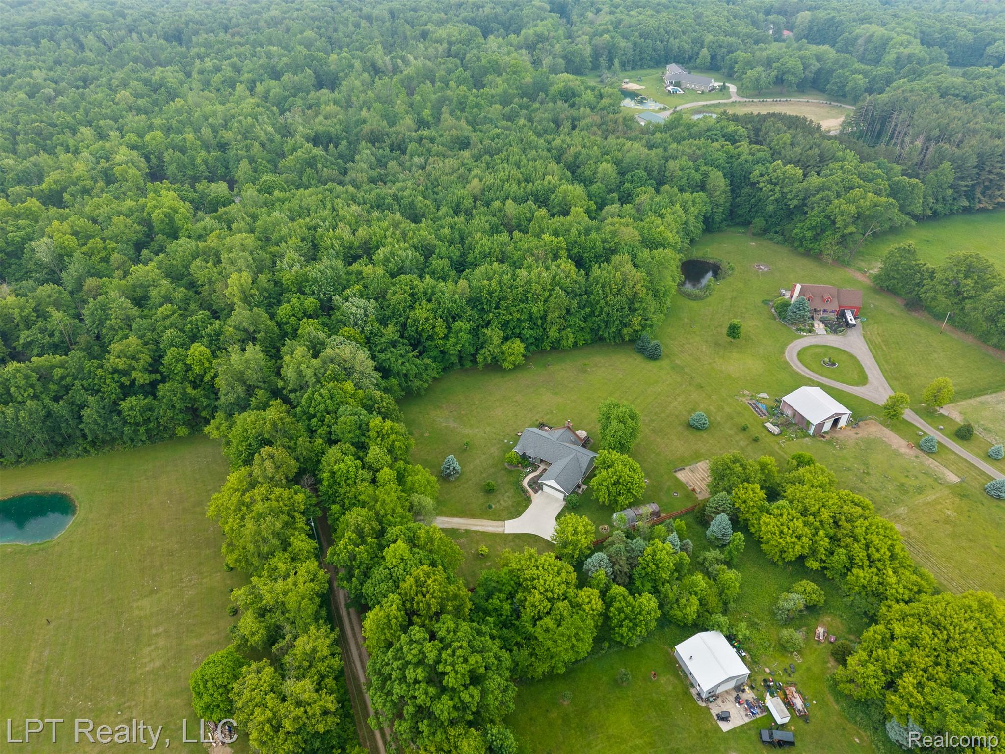 2588 East Jones Road Howell, MI 48855 - Photo 27 of 40 Drone / aerial view of a heavily wooded area