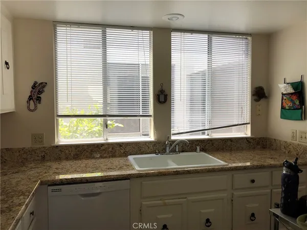 a kitchen with granite countertop a sink and a window