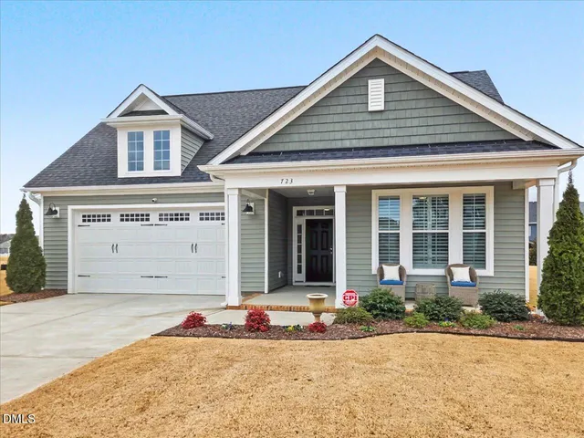 a hallway with painting on the wall and a window