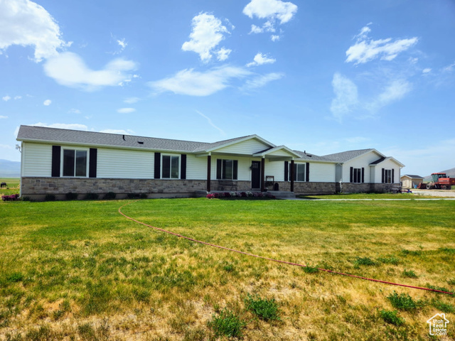 2923 Chesterfield Road Bancroft, ID 83217 - Photo 1 of 1 Ranch-style home featuring a front lawn and stone siding