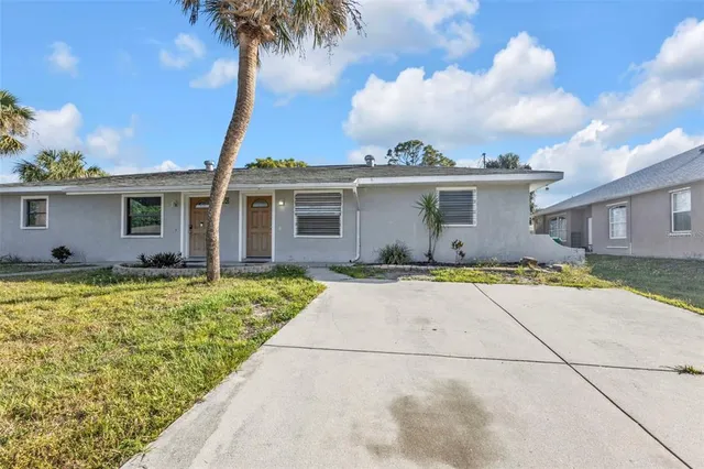 a view of a house with a backyard