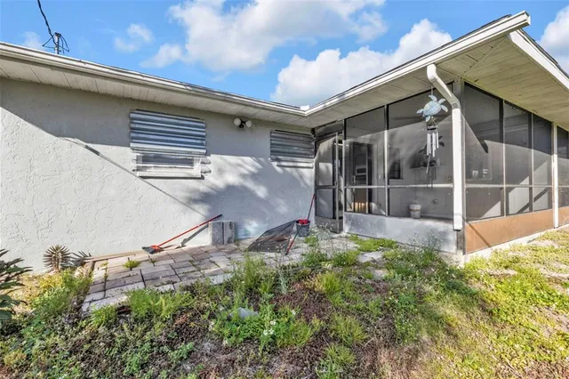 a backyard of a house with table and chairs