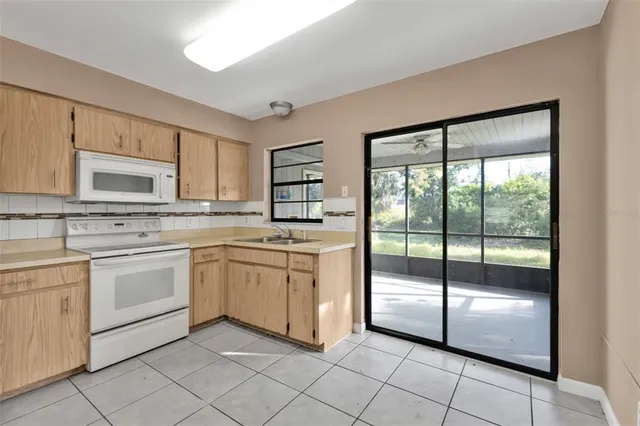 a kitchen with white cabinets and white appliances