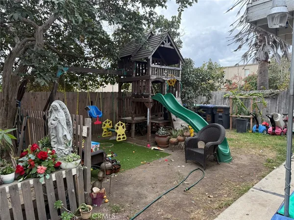 a front view of a house with garden and plants