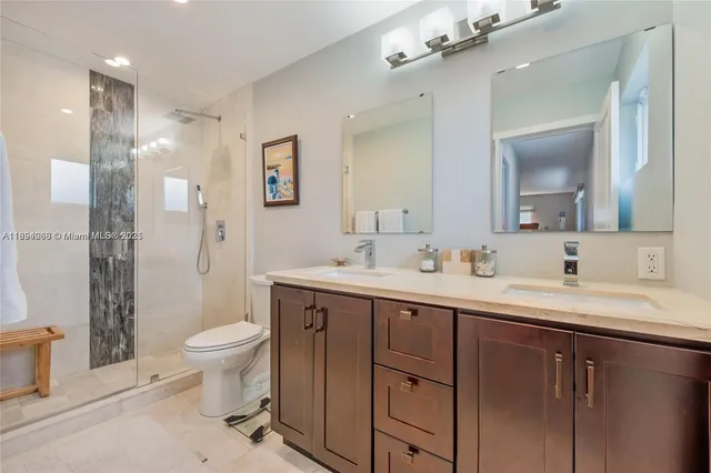 a view of bathroom with a sink mirror toilet and shower