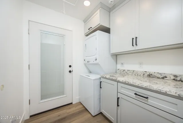 a utility room with cabinets washer and dryer