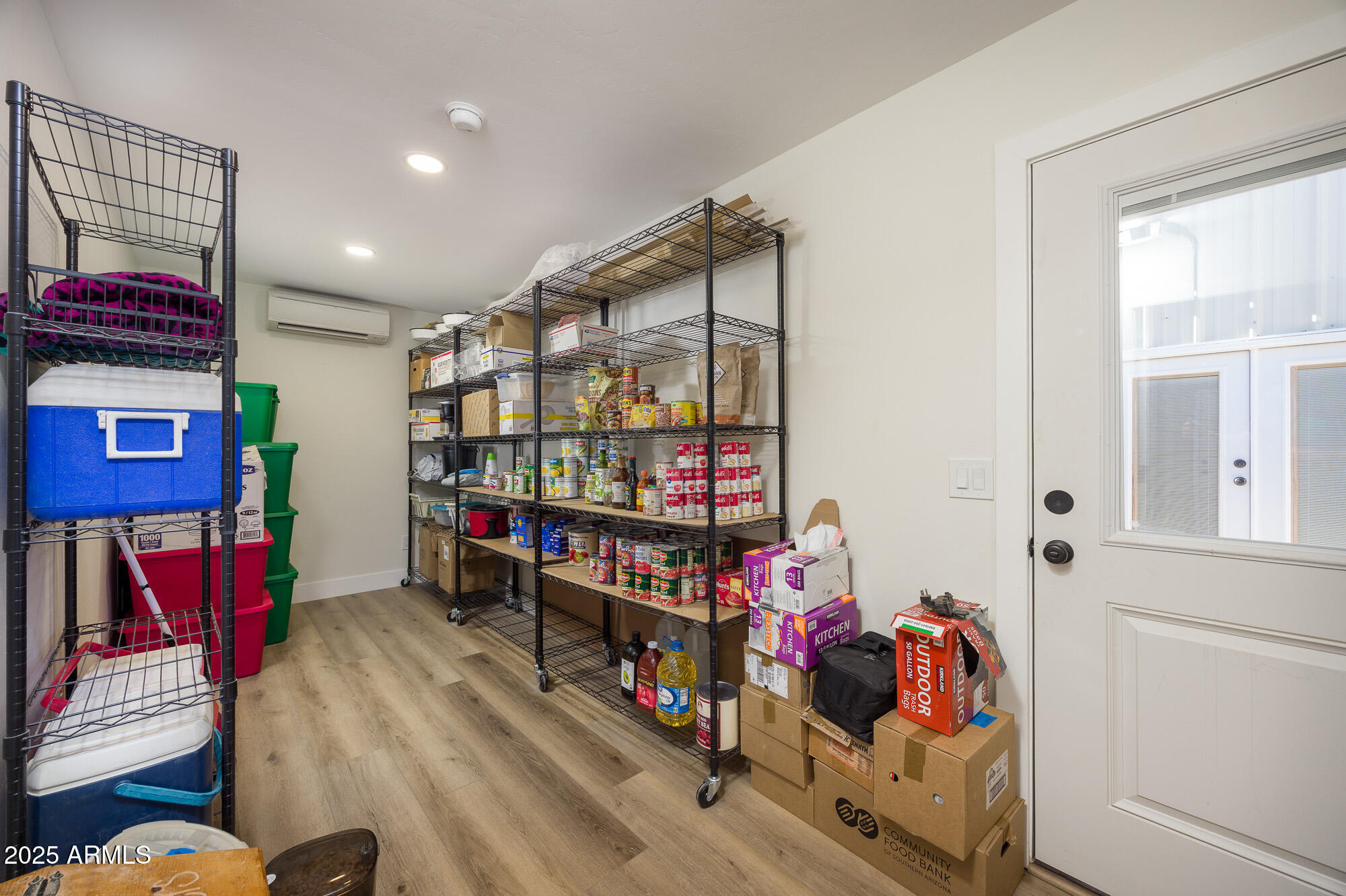 1302 West Coyote Trail Benson, AZ 85602 - Photo 13 of 57 a room with lots of different colored cloths
