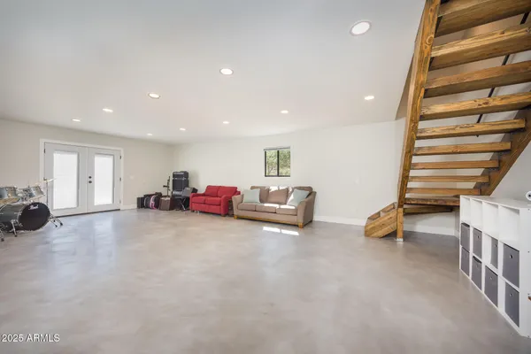 a view of a room with wooden floor and fan