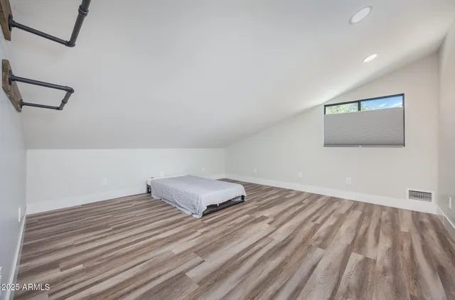 a view of a room with wooden floor and fan