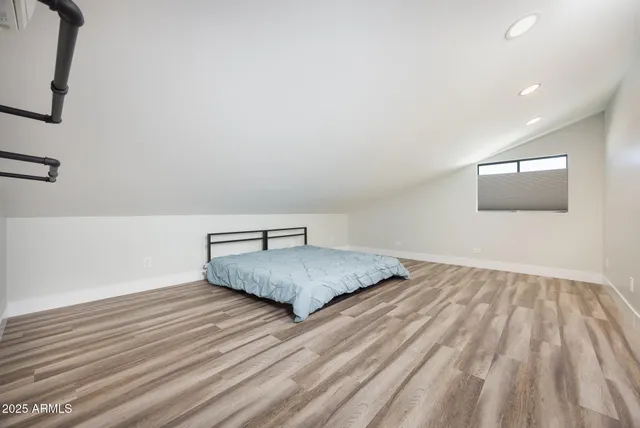 a bedroom with a bed and mirror