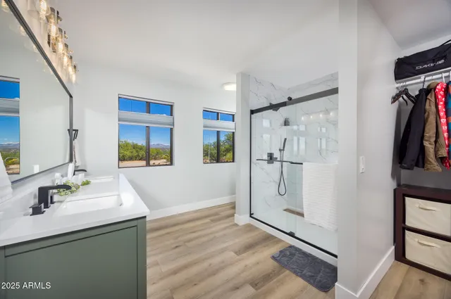 a spacious bathroom with a shower sink and mirror
