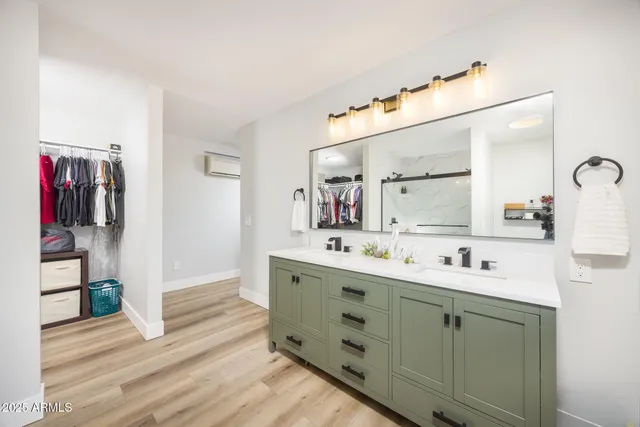 a bathroom with a double vanity sink and a mirror