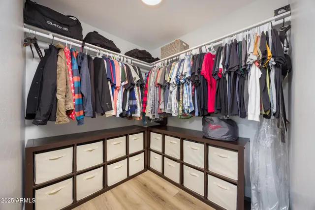 a view of walk in closet with clothes