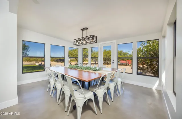 a view of a dining room and livingroom with furniture window and outside view
