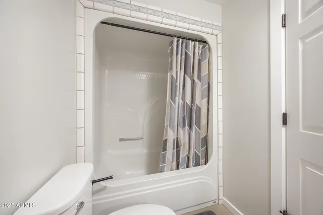 a bathroom with a toilet and a bathtub