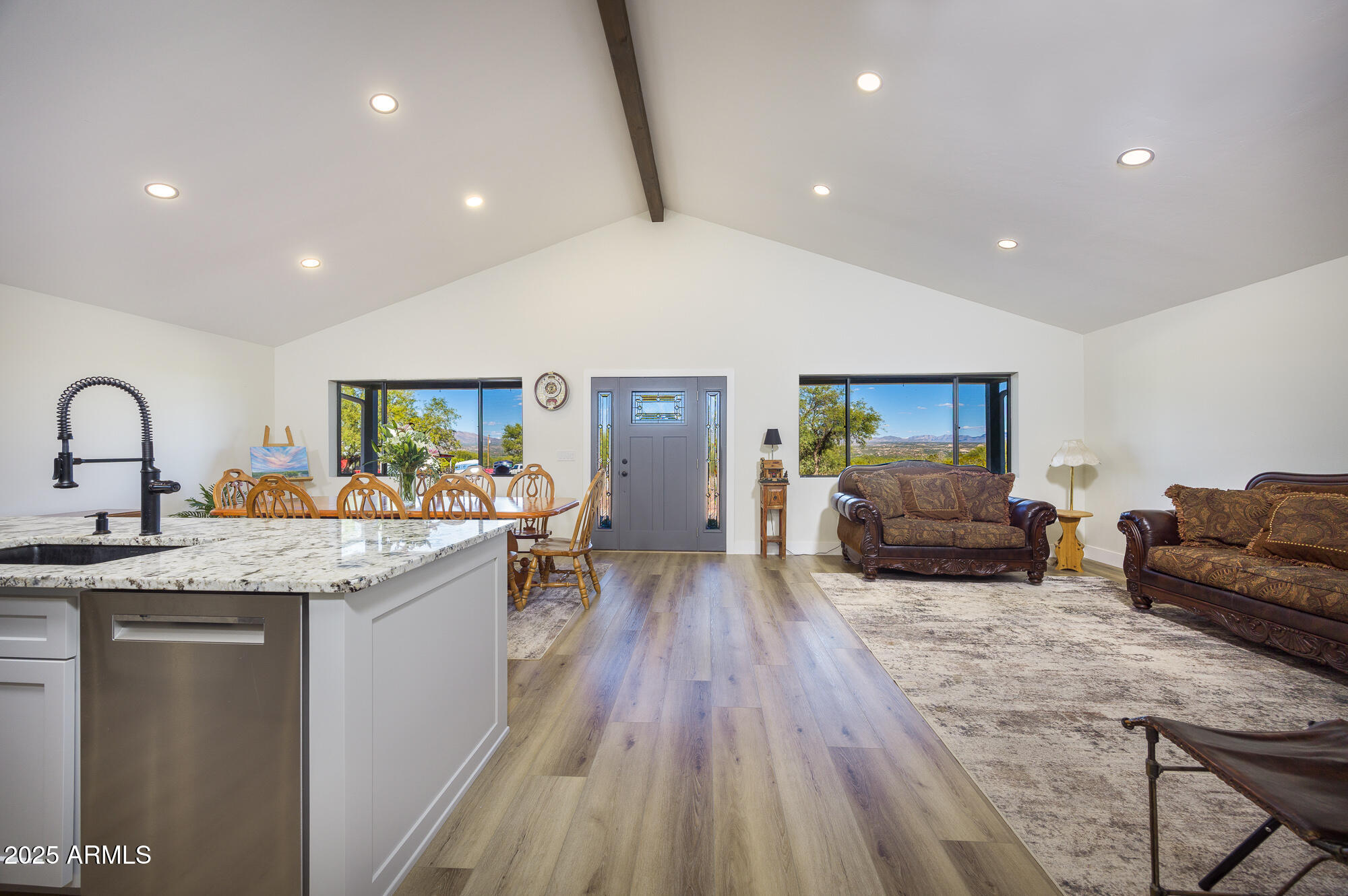 1302 West Coyote Trail Benson, AZ 85602 - Photo 6 of 57 a living room with furniture and a wooden floor