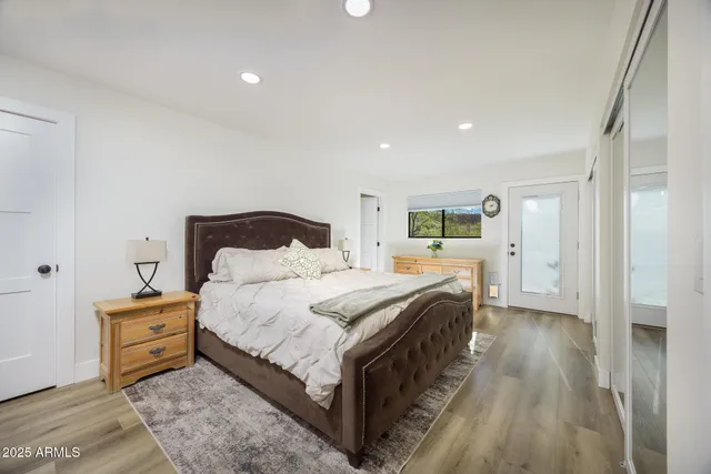 a spacious bedroom with a bed and a cabinets