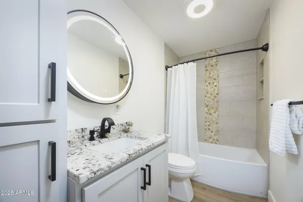 a utility room with cabinets washer and dryer