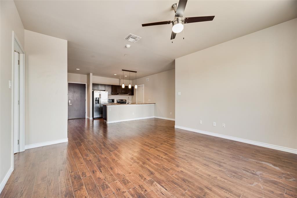 1100 West Trinity Mills Road, Unit 2040 Carrollton, TX 75006 - Photo 8 of 21 a view of kitchen with wooden floor electronic appliances and window