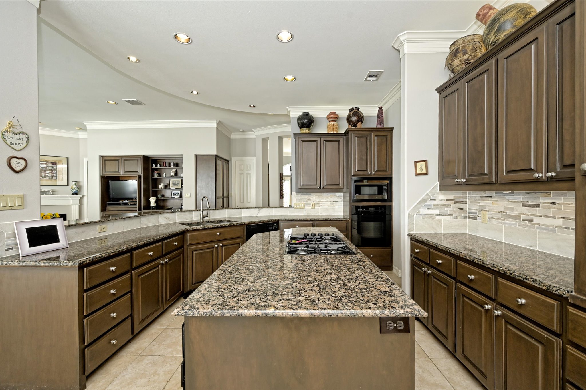 4912 Interlachen Lane Austin, TX 78747 - Photo 8 of 39 a kitchen with kitchen island granite countertop a sink stove and refrigerator