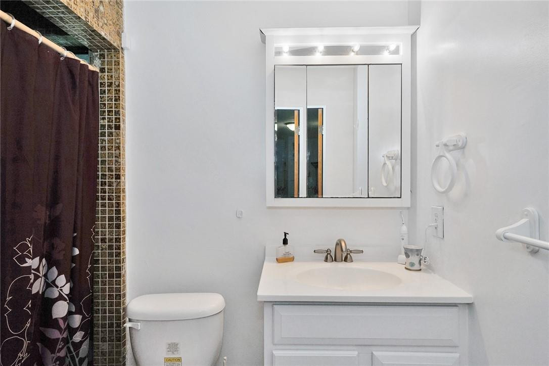 17020 Southwest 62nd Street Southwest Ranches, FL 33331 - Photo 17 of 44 a bathroom with a sink vanity mirror and toilet