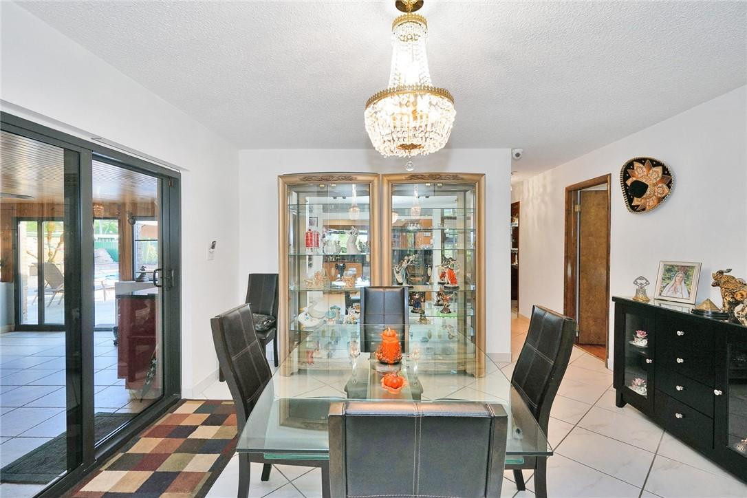 17020 Southwest 62nd Street Southwest Ranches, FL 33331 - Photo 23 of 44 a view of a dining room with furniture wooden floor and chandelier