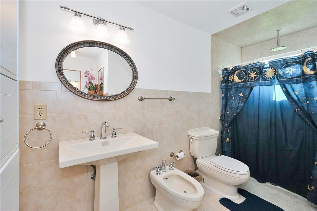 17020 Southwest 62nd Street Southwest Ranches, FL 33331 - Photo 33 of 44 a bathroom with a toilet a sink and a mirror