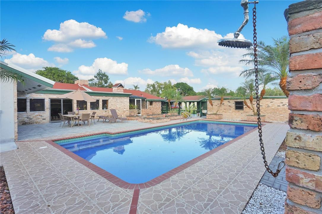 17020 Southwest 62nd Street Southwest Ranches, FL 33331 - Photo 8 of 44 a view of a patio with swimming pool table and chairs
