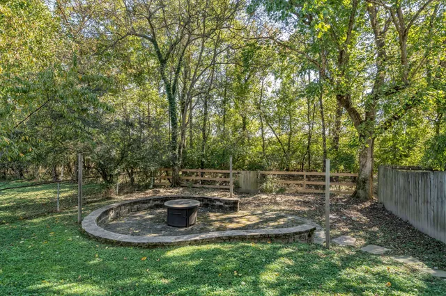 a view of a brick house with a yard and large windows