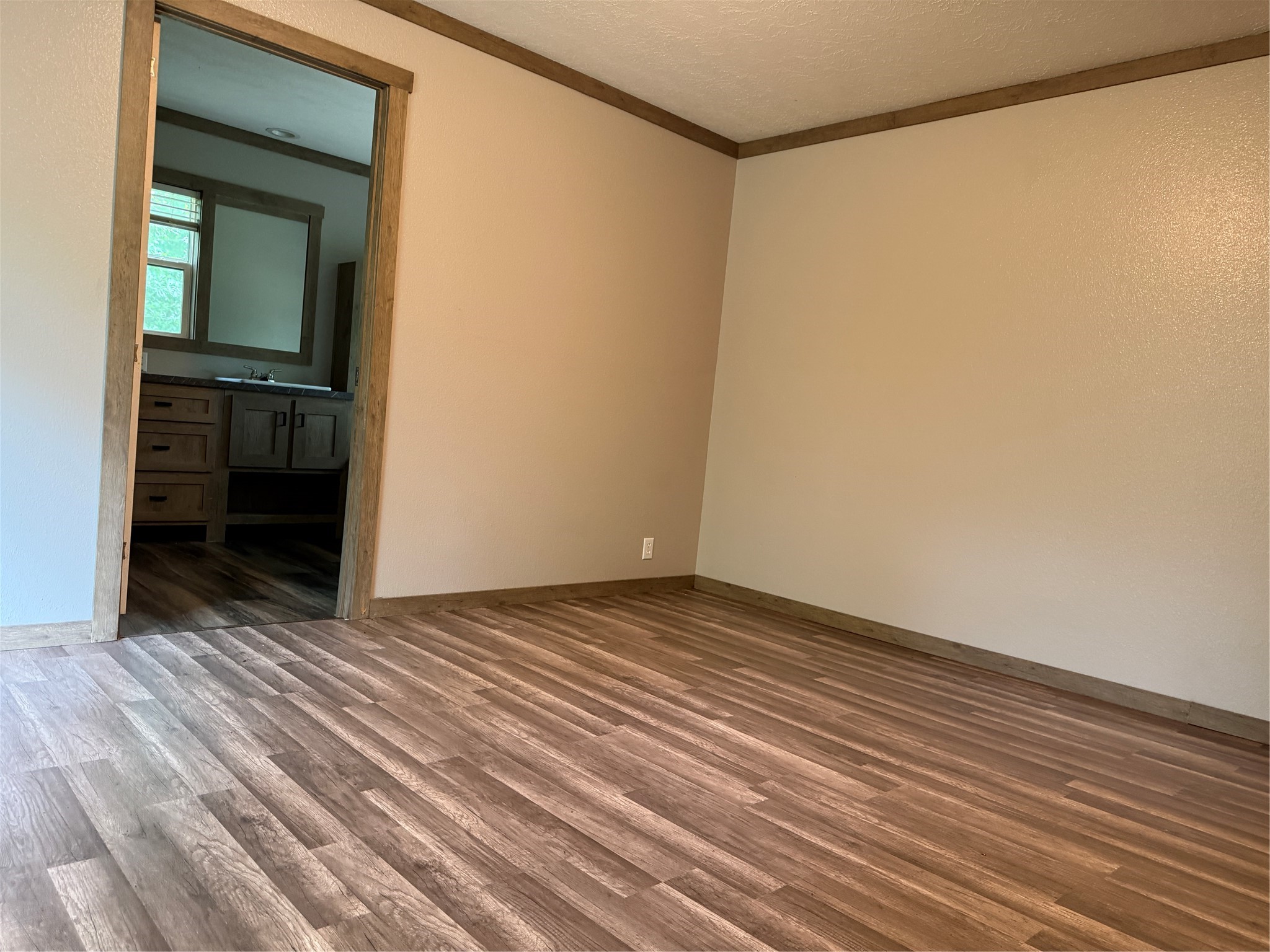 105 Saddle Surrey Road Coldspring, TX 77331 - Photo 40 of 48 a view of an empty room with wooden floor and a window