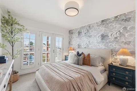 a bedroom with a large bed and a window