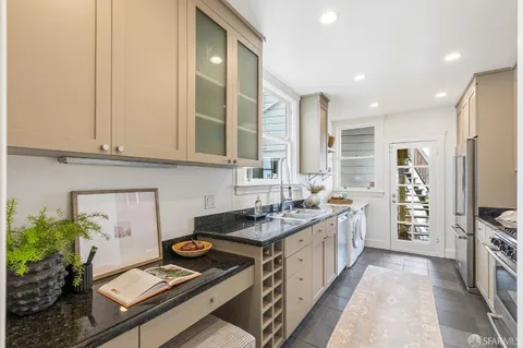 a kitchen with a sink stove and cabinets