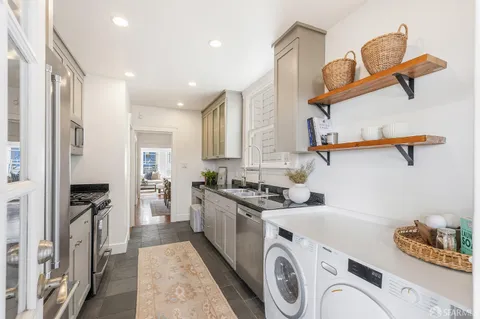 a kitchen with a refrigerator and a sink