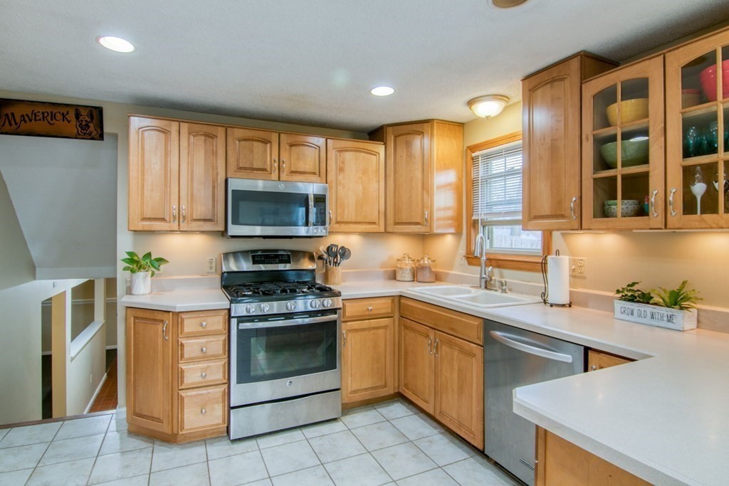 127 Sawmill Road Springfield, MA 01118 - Photo 4 of 28 a kitchen with a stove top oven sink and cabinets