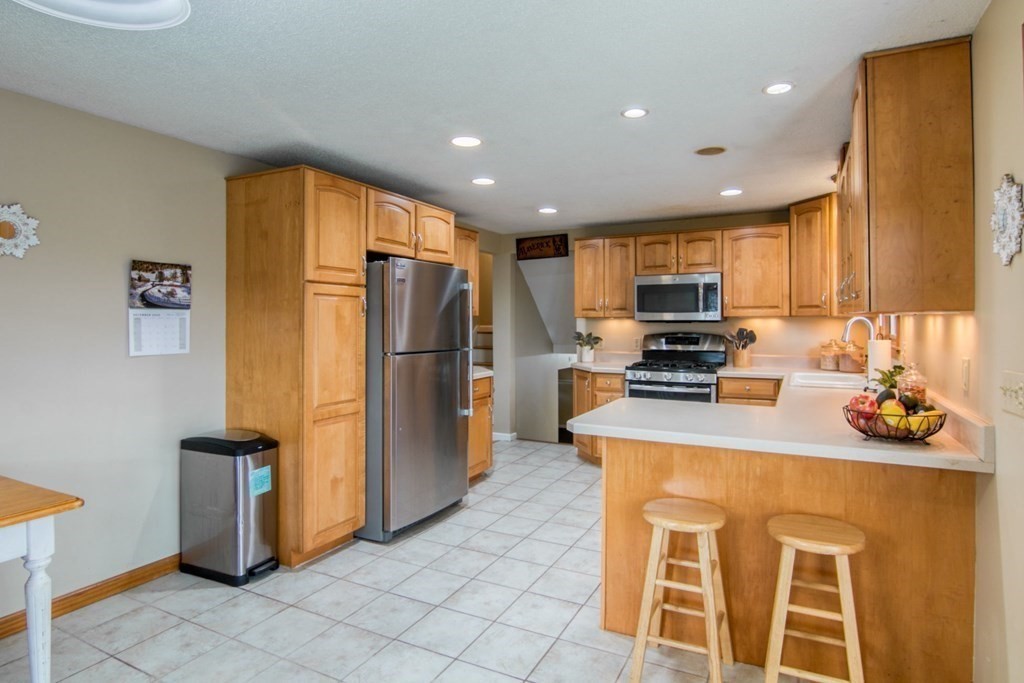 127 Sawmill Road Springfield, MA 01118 - Photo 8 of 28 a kitchen with granite countertop a refrigerator and a stove