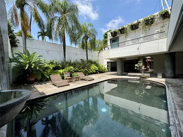 a view of a swimming pool with chairs
