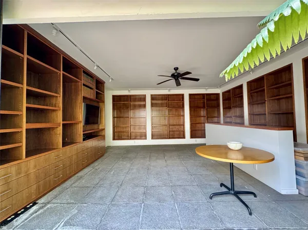a living room with a furniture and a potted plant