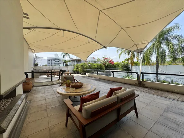 a outdoor space with lots of white furniture
