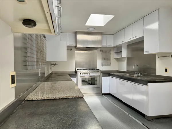 a large kitchen with a stove and a sink