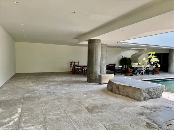 a lobby with furniture and a potted plant