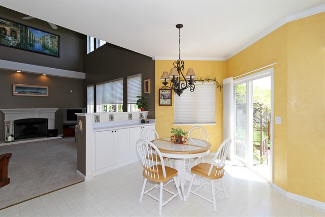 409 Inverness Drive Gurnee, IL 60031 - Photo 11 of 25 a dining room with furniture a chandelier and kitchen view