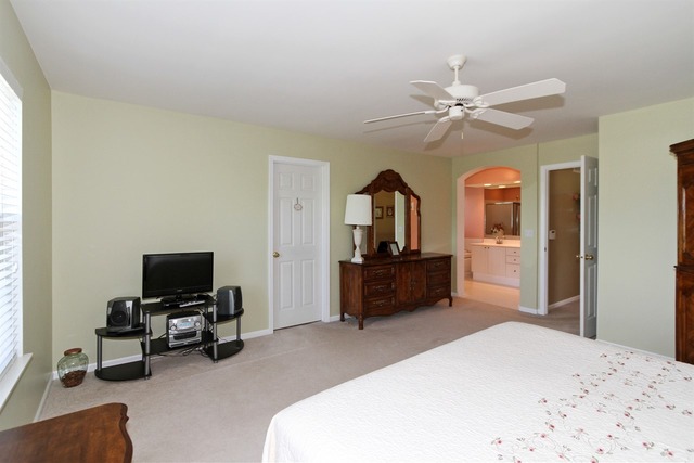 409 Inverness Drive Gurnee, IL 60031 - Photo 16 of 25 a bedroom with a bed and a flat screen tv
