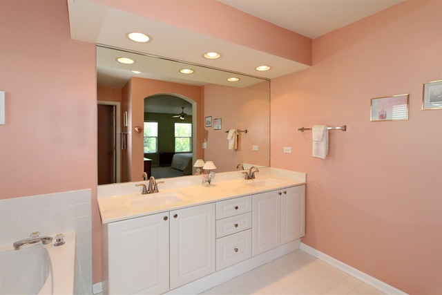 409 Inverness Drive Gurnee, IL 60031 - Photo 18 of 25 a spacious bathroom with a double vanity sink and a mirror