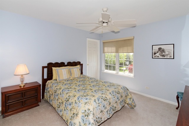 409 Inverness Drive Gurnee, IL 60031 - Photo 20 of 25 a bedroom with a bed and a chandelier