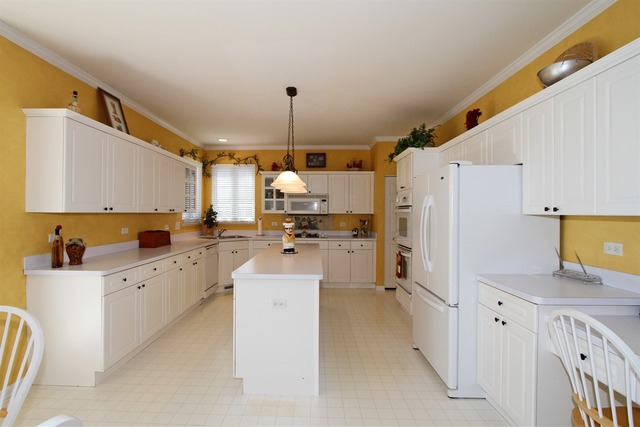 409 Inverness Drive Gurnee, IL 60031 - Photo 8 of 25 a kitchen with white cabinets and refrigerator