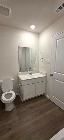 a bathroom with a double vanity sink toilet and a mirror