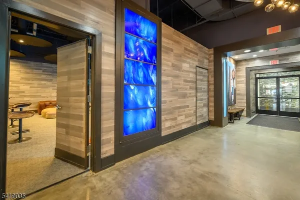 a view of a hallway with wooden floor and entryway